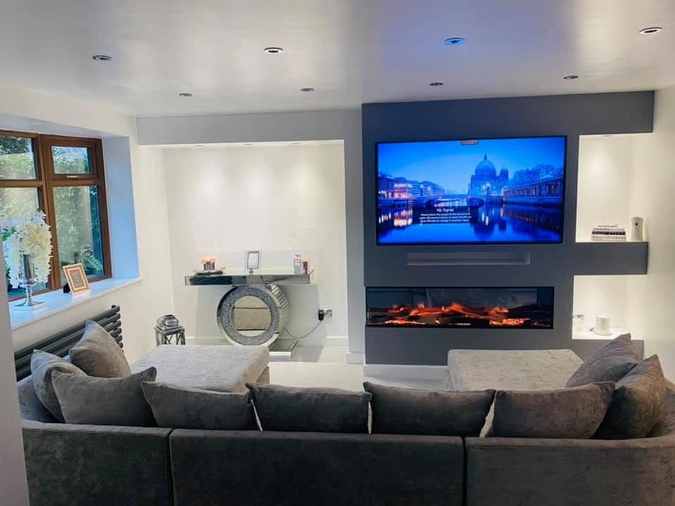 Bespoke grey media wall with an electric fire and mounted TV