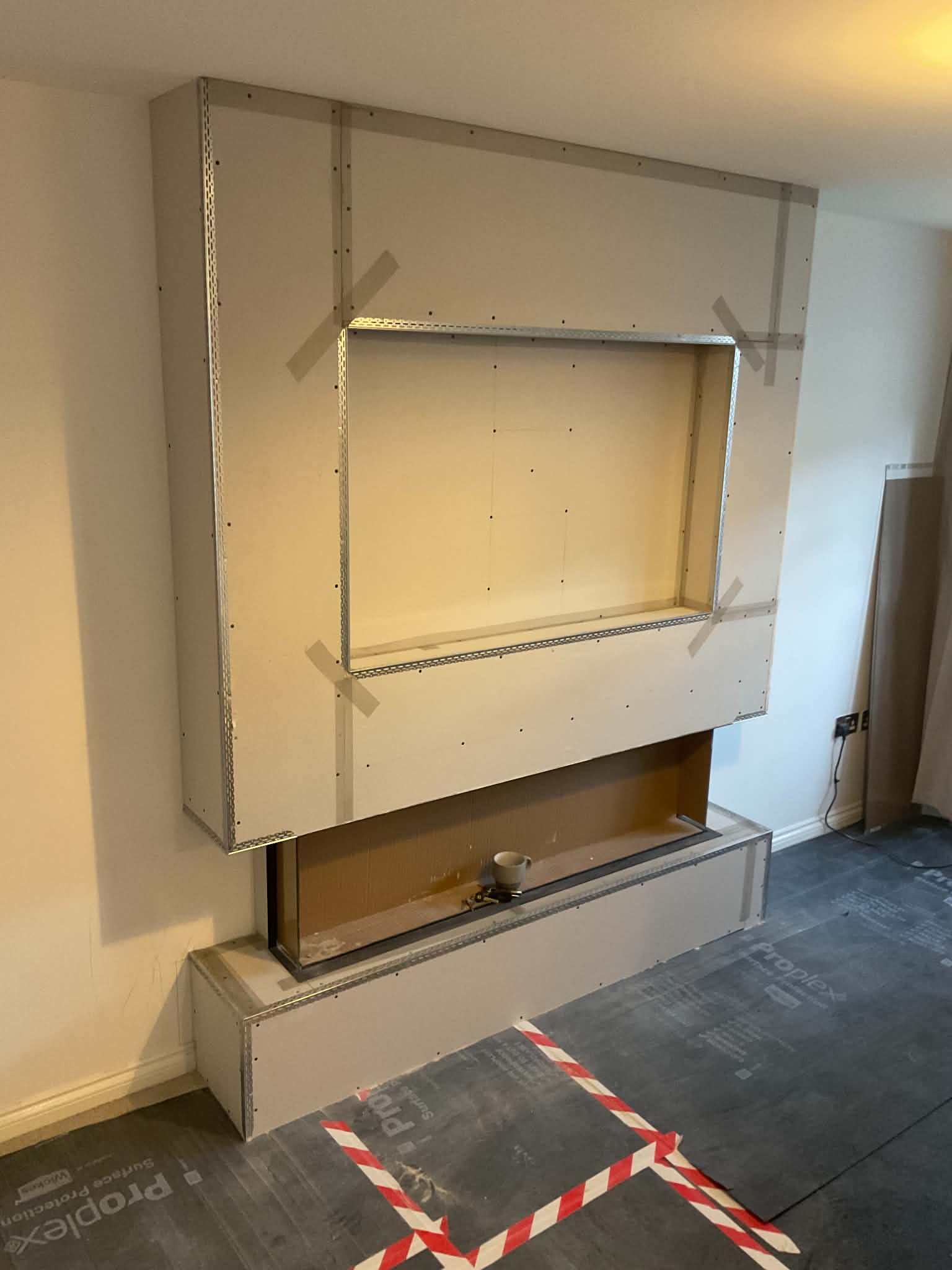 Media wall at the plaster stage with the fire fitted